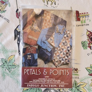 May include: A sewing pattern envelope titled Petals & Points by Indygo Junction, Inc. The cover displays two vests with patchwork triangle designs and floral appliques, worn over button-down shirts. The pattern is for sizes S-XL.
