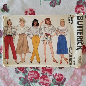 May include: A vintage sewing pattern for women's clothing. The pattern is for a skirt, pants, and shorts. The pattern is from Butterick and is labeled "Classics" and "Fast & Easy".