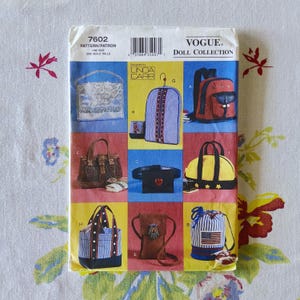 May include: A Vogue Doll Collection sewing pattern envelope, number 7602, featuring illustrations of various miniature bags and backpacks. The designs include a white beaded purse, a blue striped garment bag, a red backpack, and a drawstring bag.