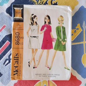 May include: Vintage McCall's sewing pattern for a misses' and junior dress in three versions. The pattern number is 8680, size 14, bust 34. The pattern is 75 cents.
