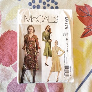 May include: A McCall's sewing pattern packet, M5178, featuring illustrations of three different dress designs. The packet shows a woman wearing a floral print dress. The size is EE (14-16-18-20).