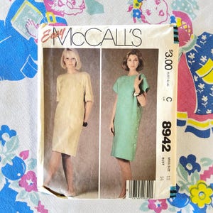 May include: Vintage McCall's sewing pattern featuring two dress designs. The pattern envelope displays images of the dresses in beige and mint green. The text on the envelope includes "Easy McCall's", the price, and the pattern number 8942.