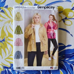 May include: Simplicity sewing pattern S8843 BB for jackets. The pattern features illustrations of four jacket styles in various colors, including a tan hooded jacket, a green jacket, a pink jacket, and a blue floral jacket. The cover shows two women wearing jackets.