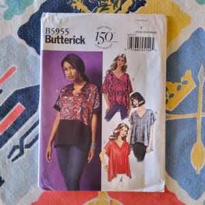 May include: A sewing pattern for a women's top with a V-neck and short sleeves. The pattern is from Butterick and is for sizes X-Small, Small, and Medium. The pattern is for a top with a loose fit and a slightly longer length in the back. The pattern is for a top that can be made in a variety of fabrics, including cotton, silk, and linen.