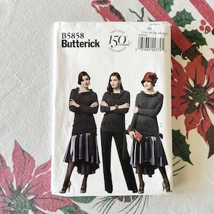 May include: A Butterick sewing pattern, B5858, featuring three women modeling different outfits. The outfits include a long-sleeved top paired with a skirt or pants. The pattern celebrates Butterick's 150th anniversary.