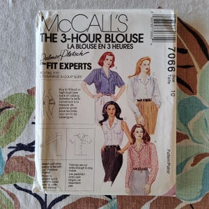 May include: A vintage McCall's sewing pattern for a 3-hour blouse. The package features illustrations of the blouse in various styles, with the text "The Fit Experts" and "No-Fail Fit!" printed on the front. Size 10.