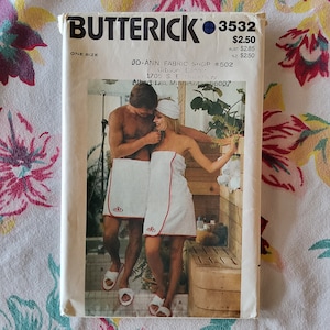 May include: A vintage sewing pattern for a couple's matching bathrobe set. The pattern is for Butterick pattern number 3532 and is for one size. The pattern shows a couple wearing white bathrobes with red trim and embroidered initials.