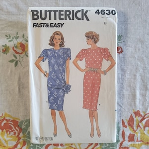 May include: A vintage sewing pattern for a dress, featuring two models wearing different styles. The pattern is from Butterick, size 8, and is labeled "Fast & Easy".