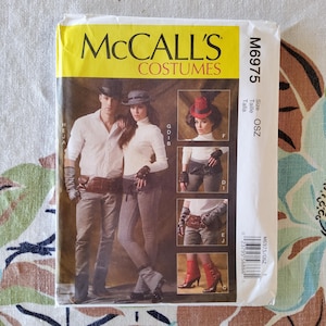May include: A McCall's Costumes sewing pattern, M6975, featuring images of steampunk-inspired outfits. The pattern includes a man and woman in white shirts and gray pants, and close-ups of accessories like gloves and a red hat.