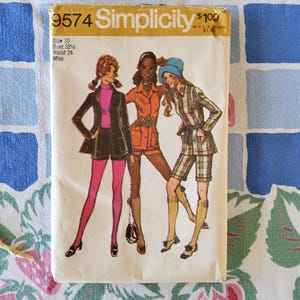 May include: Vintage Simplicity sewing pattern number 9574 for a miss's outfit. The pattern includes three different looks: a black jacket with pink shorts, a rust-coloured shirt with shorts, and a plaid shirt with shorts. The pattern is for sizes 10, bust 32 1/2, waist 24.