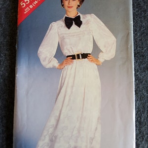 May include: A vintage sewing pattern for a white dress with a black bow and belt. The pattern is from See & Sew and is size B (14-16-18).