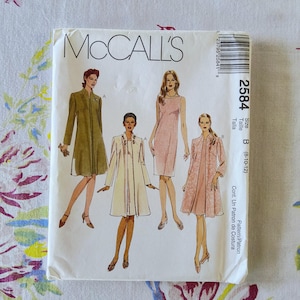 May include: A McCall's 2584 sewing pattern envelope for sizes 8-10-12. The front features illustrations of four outfits: an olive green coat, a cream coat with embellished lapels, a sleeveless pink dress, and a pink dress with a matching coat.