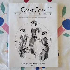May include: A sewing pattern for a cap sleeve shell and straight skirt. The pattern is designed for conventional or serger sewing. The pattern includes three different views of the garment.