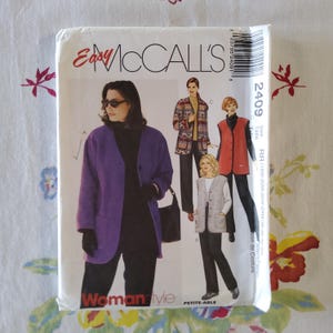 May include: A sewing pattern for a woman's jacket and vest. The pattern is from McCall's and is called "Easy McCall's Woman Style." The pattern is for sizes 18W-20W-22W-24W-00-0. The pattern shows a purple jacket, a red vest, and a gray vest.