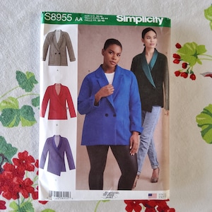 May include: Simplicity sewing pattern number S8955 AA for sizes US 10-18, Euro 36-44. The pattern includes instructions for making three different styles of blazers: a double-breasted blazer with a blue fabric, a red wrap blazer, and a purple blazer with a shawl collar.