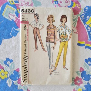 May include: A vintage Simplicity sewing pattern envelope numbered 5436, featuring illustrations of three different outfits including a collared shirt with striped trousers, a sleeveless striped top with white trousers, and a floral shirt with yellow trousers.