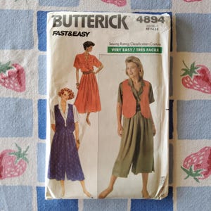 May include: A Butterick sewing pattern, number 4894, featuring three fashion illustrations. The pattern is labeled "Fast & Easy" and includes the size range 12-14-16. The sewing rating is "Very Easy". The cover shows a woman in a jumpsuit.