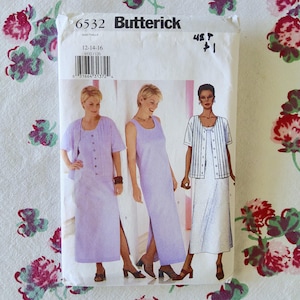 May include: A Butterick sewing pattern envelope featuring three women modeling different dress styles. The envelope is white with the number "6532" and the Butterick logo. The dresses are various shades of lavender and white.