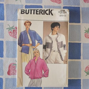 May include: A Butterick 3184 sewing pattern envelope for sizes 8-10-12. The front displays illustrations of three jacket styles: a blue jacket, a pink jacket with a gathered hem, and a white jacket with grey horizontal color-blocked panels.