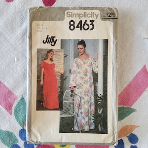 May include: Simplicity sewing pattern number 8463 for a Jiffy dress. The pattern includes two dress styles, one in red and one in a floral print. The pattern is for petite and miss sizes 6-8.