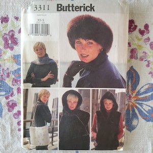 May include: A sewing pattern for a fur vest and hat. The pattern is for sizes XS-S and is from Butterick. The pattern includes instructions for making a vest with a hood and a hat with a fur trim.
