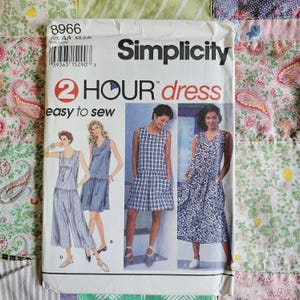 May include: A Simplicity 8966 sewing pattern envelope for a 2 Hour dress. The white paper packaging features the text 2 HOUR dress easy to sew and displays four illustrations of sleeveless dresses in various patterns and lengths.