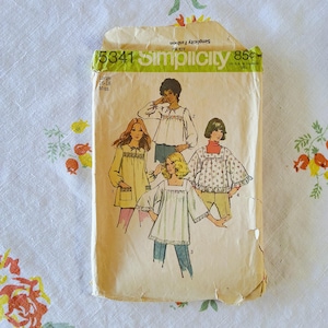May include: Vintage Simplicity sewing pattern envelope. The envelope is tan with the number 5341 and the word Simplicity in green. The envelope features illustrations of four different tops. The size is Large 16-18 Miss.