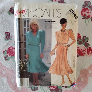 May include: A sewing pattern for a dress with a V-neckline and short sleeves. The pattern is called "Easy McCall's" and the pattern number is 2943. The pattern is for sizes 6-8-10.