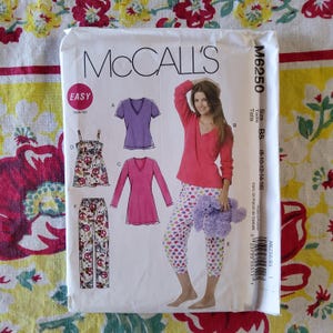 May include: A McCall's sewing pattern envelope, M6250, featuring illustrations of pajamas and sleepwear. The envelope shows a woman wearing a red long-sleeved top and heart-patterned capri pants. The pattern includes sizes B5 (8-10-12-14-16).