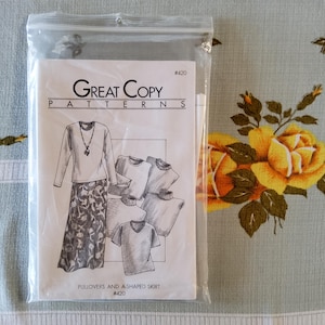 May include: A sewing pattern for pullovers and an A-shaped skirt. The pattern is from Great Copy Patterns and is number #420. The pattern shows a woman wearing a long-sleeved pullover with a skirt and a necklace. There are also drawings of four different pullovers.