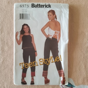 May include: A sewing pattern for a teen girl's outfit. The pattern includes instructions for a halter top and pants. The pattern is from Butterick and the pattern number is 6573.