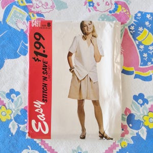 May include: A McCall's sewing pattern envelope labeled 6491, size B, featuring a photograph of a white V-neck short-sleeve top and tan knee-length skirt. The red side panel displays the text Easy Stitch 'n Save and the price of $1.99.