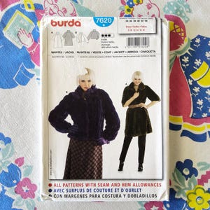 May include: A Burda sewing pattern envelope, model 7620, featuring images of a fur coat and jacket. The envelope includes size charts and text in multiple languages, including English, French, and Spanish.