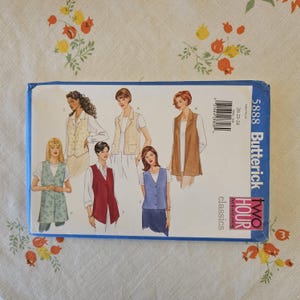 May include: A Butterick 5888 sewing pattern envelope for vests in sizes 20-22-24. The front features illustrations of five different vest styles in various colors including light green, cream, brown, red, and blue, worn over white shirts.