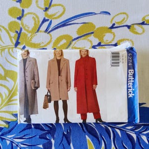 May include: A Butterick sewing pattern packet featuring three coat designs in various colors. The coats are shown in light gray, tan, and red. The packet has a blue and white border with the number 5274 and the Butterick logo.