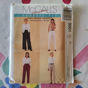 May include: McCall's pattern for classic fit trousers, size 14. The pattern includes instructions for making one-hour trousers, also known as pantalon en 1 heure. The pattern shows four different views of the trousers, including a white pair, a black pair, a burgundy pair, and a khaki pair.