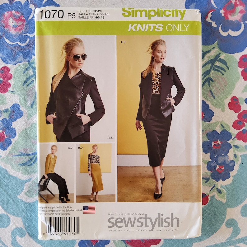 May include: Simplicity sewing pattern 1070 P5 for knit fabrics, sizes UK 12-20, Euro 38-46, French 40-48. The pattern includes instructions for a jacket with a fold-over collar and a skirt. The model is wearing a black jacket with a fold-over collar and a black skirt. The pattern also includes instructions for a top with a scoop neck and a skirt.