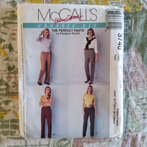May include: McCall's Classic Fit sewing pattern for The Perfect Pants. The pattern features multiple styles of pants, with the size range of 20-22-24. The pattern includes the text "Le Pantalon Parfait".