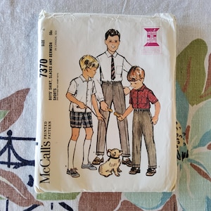 May include: Vintage McCall's printed pattern for boys' shirt, slacks, and Bermuda shorts. The illustration shows three boys and a dog. The pattern is size 6 and priced at 50c, 60c in Canada. The McCall's logo is visible.