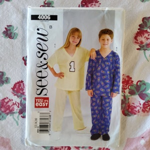 May include: A sewing pattern for children's pajamas. The pattern is for a long-sleeved shirt and pants. The pattern is from the brand "see & sew" and is labeled "4006". The pattern includes a yellow shirt with a number "1" on the front and blue pants with a butterfly print. The pattern also includes a blue shirt with a butterfly print and blue pants with a butterfly print.