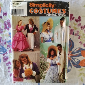 May include: Simplicity sewing pattern for costumes, featuring four different outfits. The pattern is for adult sizes and includes instructions for making a pink ball gown, a blue and white dress, a white suit, and a purple suit.