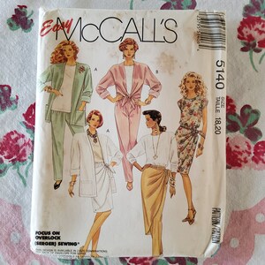 May include: A sewing pattern for four different outfits. The pattern is for sizes 18 and 20. The pattern is called McCall's Easy 5140. The pattern includes a green pantsuit, a pink jumpsuit, a floral wrap dress, and a white top with a brown wrap skirt.