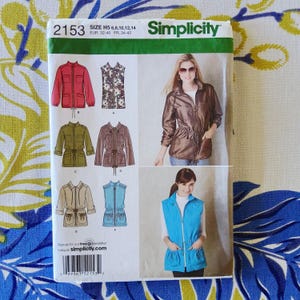 May include: Simplicity sewing pattern 2153. The pattern features illustrations of jackets and vests in various colors, including red, green, and blue. The pattern includes sizes H5: 6, 8, 10, 12, and 14. The Simplicity logo is visible.