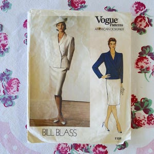 May include: Vogue Patterns sewing pattern featuring a Bill Blass design. The pattern cover shows a woman in a cream-colored skirt suit and a woman in a navy blue blazer and white skirt. The pattern number is 1158.