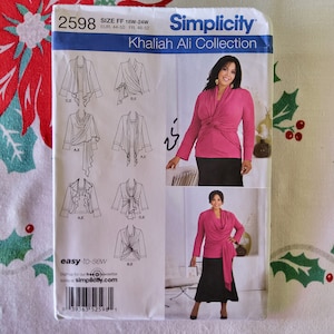May include: A sewing pattern for a wrap top with a variety of styles. The pattern is from Simplicity and is part of the Khaliah Ali Collection. The pattern number is 2598 and the size is FF 18W-24W, EUR 44-50, FR 46-52.