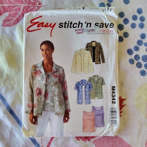 May include: A sewing pattern for a women's blouse and tank top. The pattern is from McCall's and is called "Easy Stitch 'n Save". The pattern number is M4342 and the size is 10-12-14.