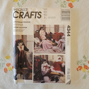 May include: A McCall's Crafts sewing pattern envelope 4344 titled A Victorian Treasure. The white paper envelope features photographs of stuffed dolls wearing various outfits including dresses, capes, and bonnets with red and white accents.