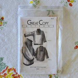 May include: A sewing pattern for a New York Style Pullover, sealed in a clear plastic bag. The pattern features illustrations of the pullover design, with the text "Great Copy PATTERNS" and "NEW YORK STYLE PULLOVER #830".