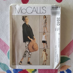 May include: A sewing pattern envelope for McCall's pattern number 3940. The envelope shows three different styles of dresses. The pattern is for sizes X-Small, Small, and Medium.