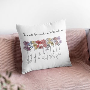 May include: White cushion with the text "Great Grandma's Garden" and a line of colourful flowers with names written underneath each flower. The names are: William, David, Hunter, Zoey, Milly, Jenny, Ava, Lucy, Mason, Sam.